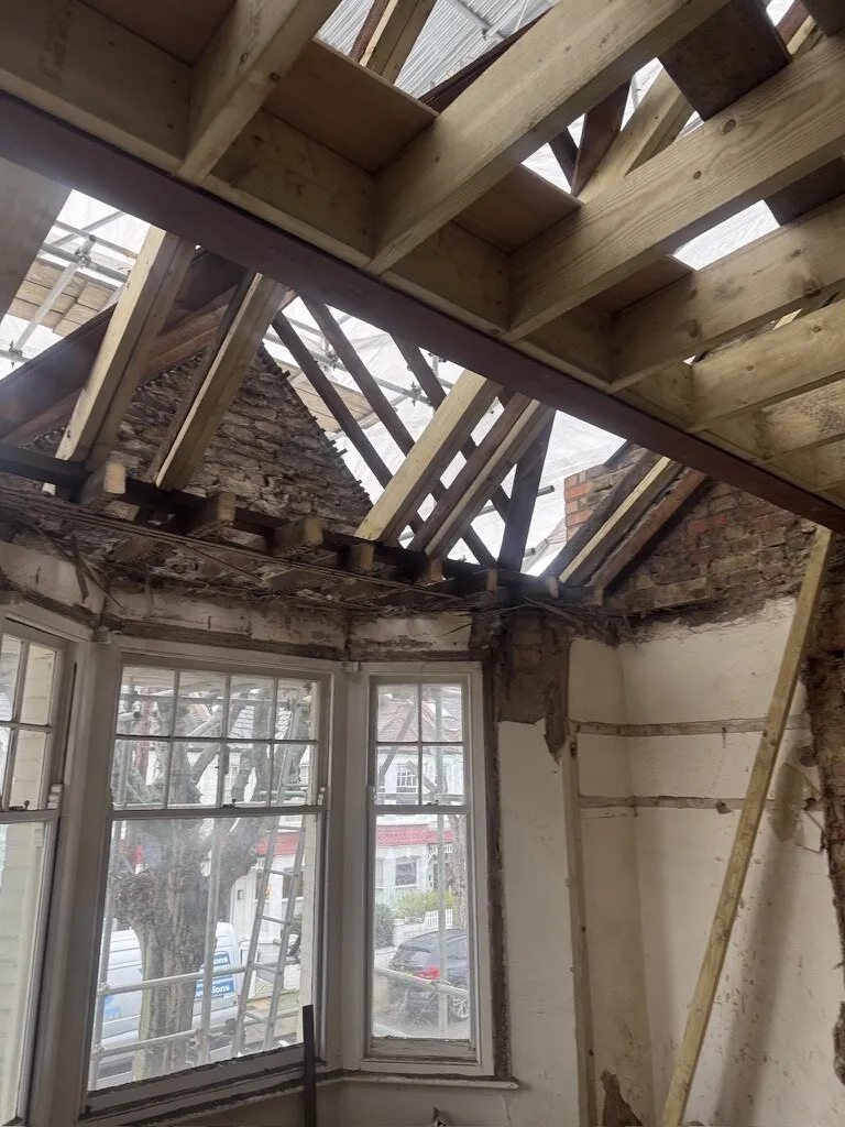 Roof opened up under a temporary cover above the front bay bedroom, with new steel and timber floor structure installed, Earlsfield loft conversion