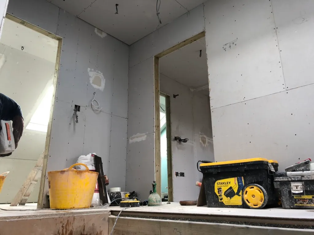 Plasterboarded loft rooms with new door openings ahead of plastering