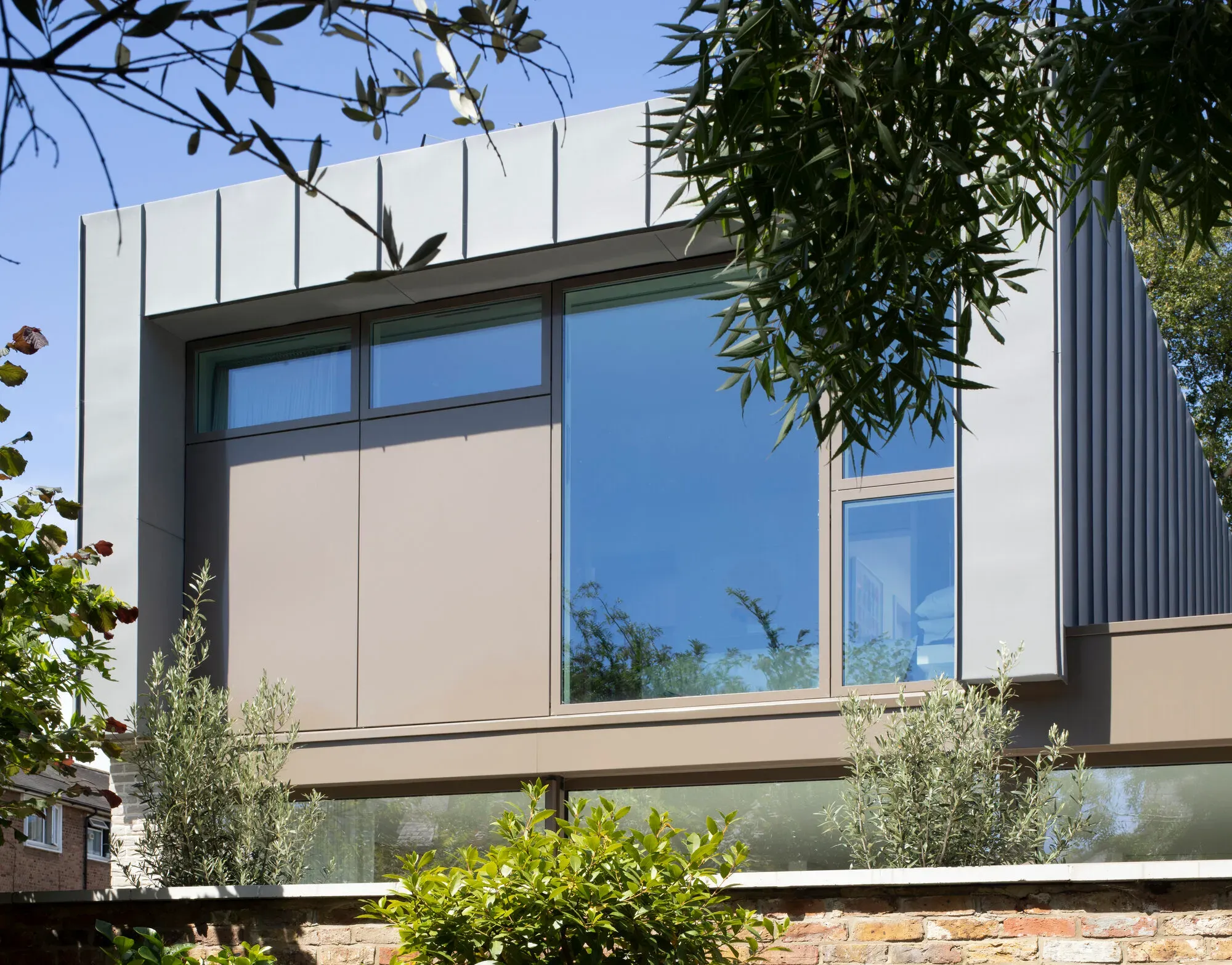 Close detail of the finished facade, cladding and window reveals